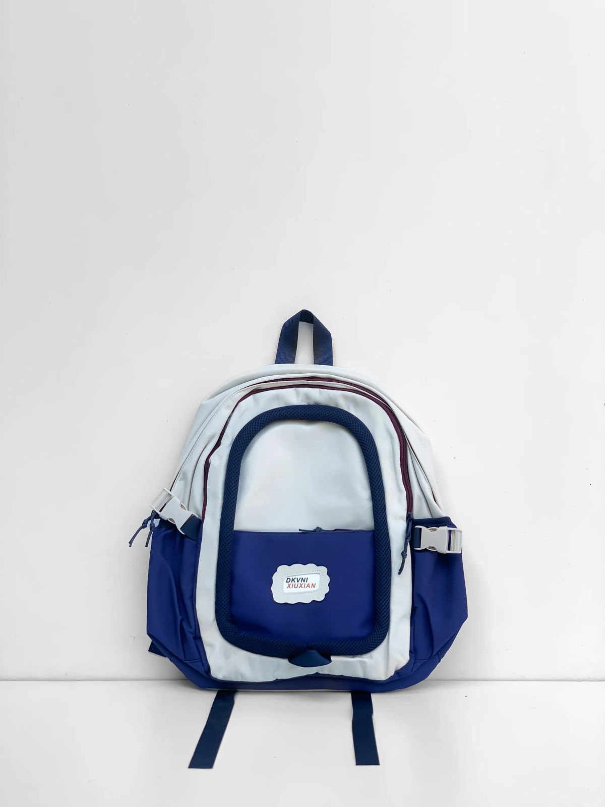 Premium Option: DKVNI XIUXIAN Urban Dual-Tone Backpack – Cobalt & Ivory  Sporty Option: DKVNI Lightweight Multi-Pocket Casual Daypack  Minimalist Option: XIUXIAN Dual-Tone Trendy Explorer Backpack