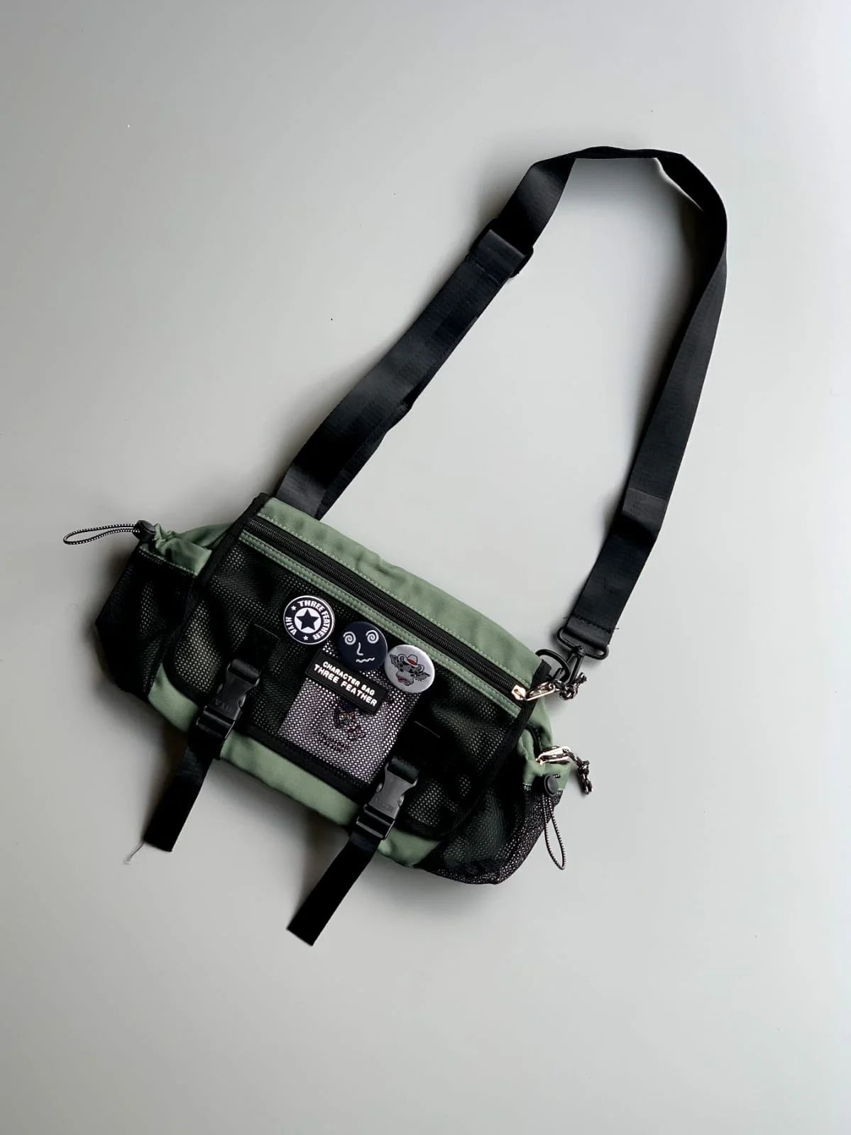 Premium Option: Three Feather Tactical Messenger Sling – Olive & Stealth Black  Sporty Option: Three Feather Urban Utility Crossbody Bag  Trend Option: Harajuku Techwear Multi-Pocket Sling Bag