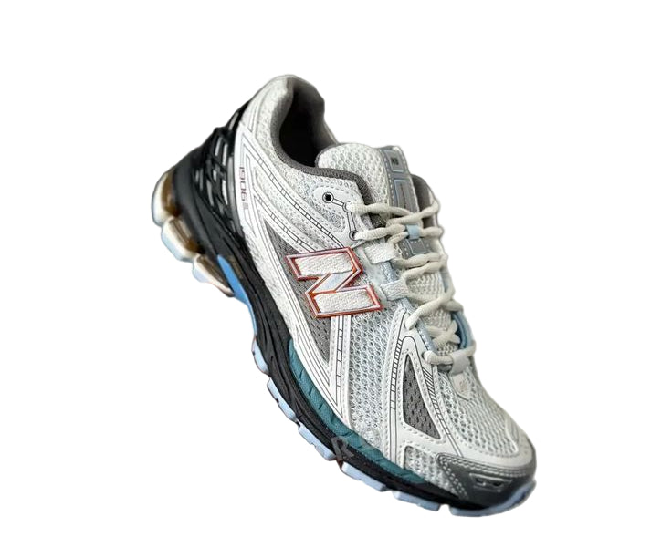 New Balance 1906R sneaker in the "White/Black/Copper" colorway.